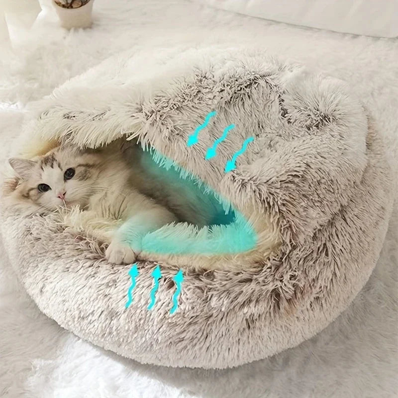 Katze in einer grauen Plüsch-Katzenhöhle mit türkisfarbenen Pfeilen zur Darstellung der Luftzirkulation