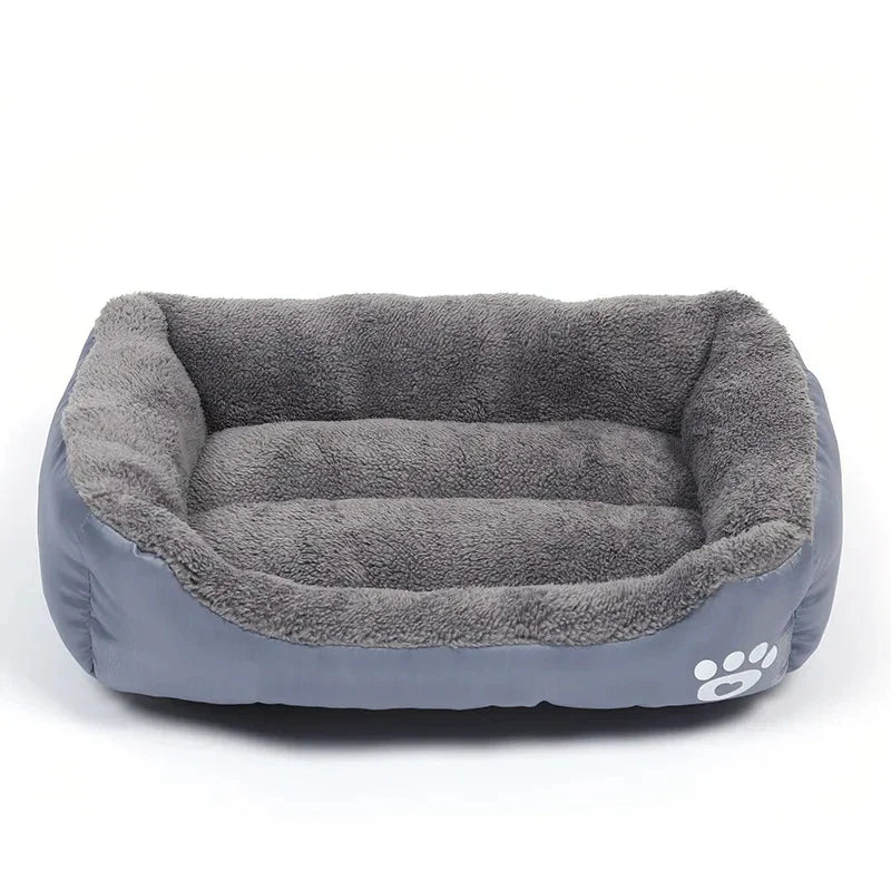 Hunde-Bett mit orangefarbenem Außenstoff und grauem Innenpolster