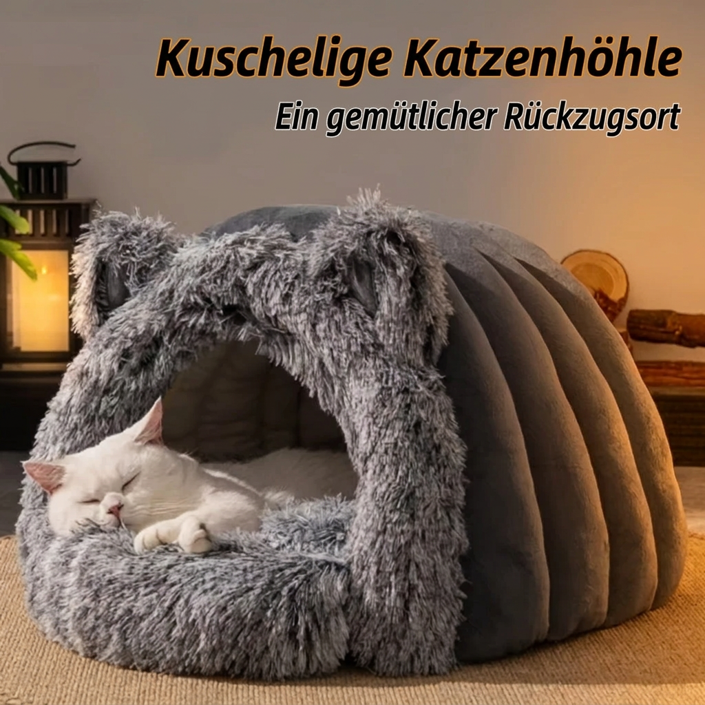 Graue Katzenhöhle mit schlafender weisser Katze und dem Schriftzug «Kuschelige Katzenhöhle – Ein gemütlicher Rückzugsort».